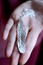 Penjoll de ploma de plata.