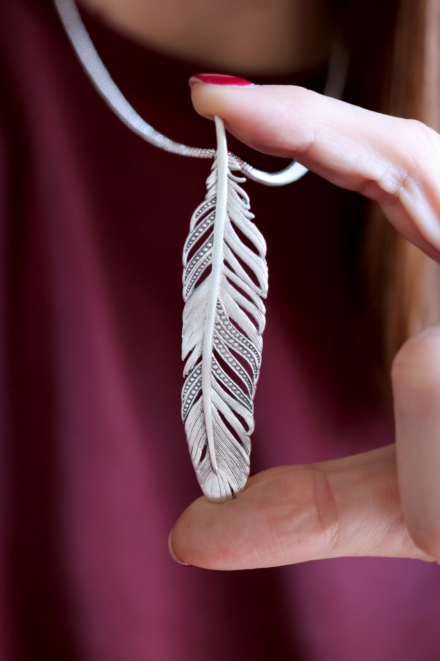 Penjoll de ploma de plata.