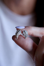Arracades fulles de plata.